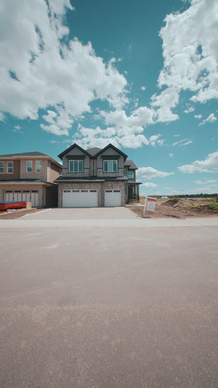Vertical reel still: new two-storey home with a for-sale sign